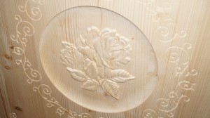 Roses in the center of the cabinet door.